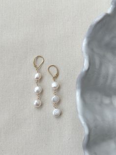 These stunning pearl drop earrings are perfect for your next special occasion! Each earring holds a strand of 3 gorgeous natural shape round Pearls with sensitive skin safe accents. The leverback clasp closure makes sure your earrings stay secure all day and night! * Natural 7x10mm off-round white Pearls * 14K Gold Filled or 925 Sterling Silver comfy and secure 17mm clasps and accents * 2.25 inch length * Made with all hypoallergenic materials 🤍 *Please note for the health and safety of my cust 14k Gold Filled Pearl Drop Earrings For Anniversary, Elegant Pearl Charm Earrings In 14k Gold Filled, Elegant 14k Gold-filled Earrings With Pearl Charm, Elegant 14k Gold Filled Earrings With Pearl Charm, 14k Gold Filled Dangle Earrings With Pearl Pendant, Classic Long Drop Pearl Earrings With Matching Pair, Classic Long Drop Pearl Earrings With Ear Wire, 14k Gold Filled Drop Earrings With Pearl Charm, Formal 14k Gold Filled Earrings With Pearl Charm