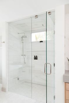 a bathroom with a walk in shower next to a sink