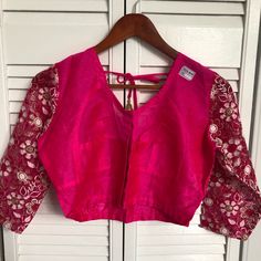 Front Of The Blouse Is Pink , Back And Sleeve Is Net And Embroidered,,Really Pretty With Saree Or Lehenga Choli .. Festive Fitted Embroidered Padded Top, Festive Pink Tops With Chikankari Embroidery, Diwali Embroidered V-neck Blouse, Pink Chikankari Embroidery Blouse, Elegant Blouse With Chikankari Embroidery For Navratri, Embroidered V-neck Top For Navratri, Pink Padded Blouse Set With Long Sleeves, Saree Blouse With Chikankari Embroidery For Party, Summer Festive Choli With Chikankari Embroidery