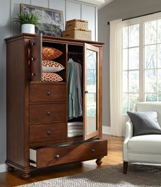 a wooden armoire with drawers in a living room