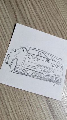 a drawing of a car on top of a wooden table