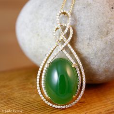 "Here is a beautiful translucent large oval green nephrite jade pendant set with pave diamonds in solid 18KT yellow gold. The jade is set in a double infinity love knott halo setting and is surrounded by pave set round diamonds. The jade is about 14x18mm and is approx. 14.45 carats. The total weight of the brilliant cut round white diamonds is 0.49 carats. The pendant is about 1 1/2\" long. The chain is 14KT gold and is 16\" long. If you do not want the chain, please convo us and we will adjust Elegant Oval Jade Jewelry, Elegant Oval Cabochon Jade Jewelry, Antique Jewelry Victorian, Double Infinity, Infinity Love, Lucky Green, Halo Setting, Double Halo, Clothes Crafts