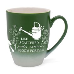 a green and white coffee mug with the words like scattered seeds memorial bloom forever