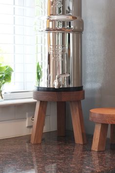 a large metal container sitting on top of a counter next to a sink and window