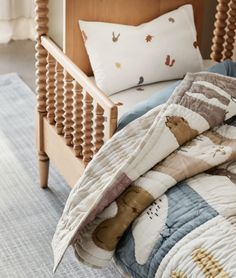 a bed with a wooden headboard and pillows on it