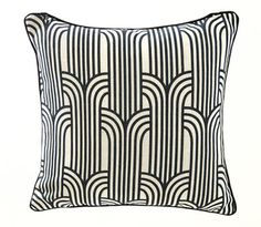 a black and white pillow with an art deco design on the front, featuring wavy lines