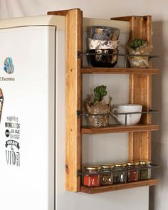 a refrigerator with shelves filled with food next to a wall