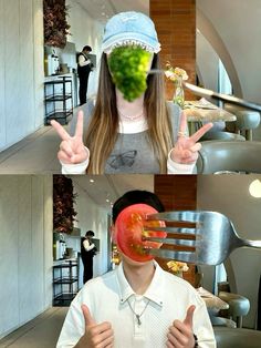 a woman making the peace sign with her hands while holding up a piece of broccoli in front of her face