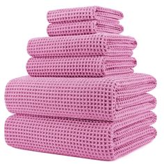 six pink towels stacked on top of each other