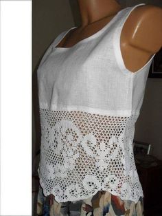 a mannequin is wearing a white top with crochet on the bottom