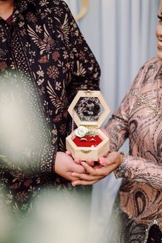 a man and woman standing next to each other holding an award in front of them