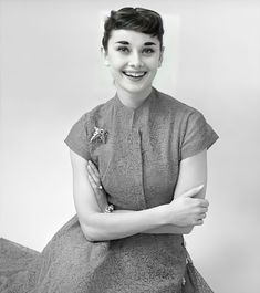 a black and white photo of a woman in a dress