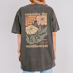 Wildflower Oversized Christian Tee Consider the Wildflowers Shirt Comfort Colors Boho Christian Apparel Women Faith Based Gift for Friend This Christian Comfort Colors shirt features a retro floral graphic with the words "consider the wildflowers" from Luke 12:27.  Size up for the oversized look. Available in ivory, espresso, pepper, and blue spruce. ✿ The With A Wildflower mission is to give God the glory and give back through a one-of-a-kind shopping experience combining faith and fashion, mod Consider The Wildflowers, Christian Comfort, Luke 12 27, Faith Based Gifts, Boho Christian, Luke 12, Blue Spruce, Floral Graphic, Women Of Faith