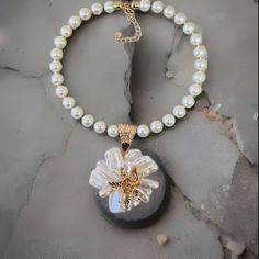 Length: 18.5" Round Glass Pearl Baroque Flower Shape Pendant Gold Tone Accents Large Gold-Tone Hook And Loop Clasp Lobster Claw Clasp With A 3" Chain Extender White Necklace With Flower Charm For Party, White Party Necklace With Flower Charm, White Flower Charm Necklace, White Flower Pendant Necklace For Parties, Elegant White Beaded Flower Necklace, White Flower-shaped Pearl Chain Necklaces, White Flower Shaped Pearl Chain Necklace, White Pearl Necklace With Flower Pendant, White Flower-shaped Necklace With Pearl Pendant