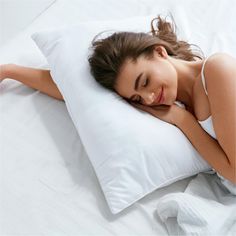 a woman laying in bed with her eyes closed