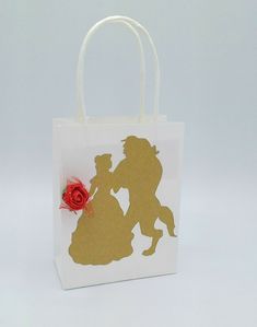 a paper bag with the silhouette of a man and woman holding a rose