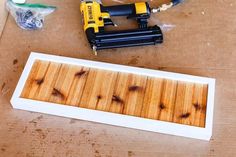 the tools are laying out on the table next to the wood planks and glue