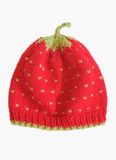 a knitted strawberry hat is shown on a white background, with green trim around the brim