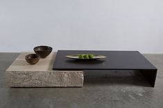 a black table with two bowls on it