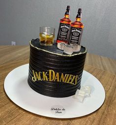 a cake made to look like two bottles of jack daniels on top of a barrel