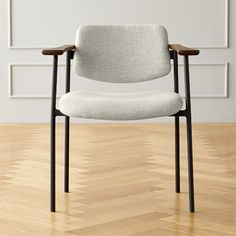 a white chair sitting on top of a hard wood floor