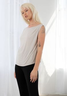 There's nothing basic about this timeless boxy fit tank top! Featuring a boat neckline that can be worn on or off the shoulder and a cool ruched detail along the left shoulder. Pair this effortless style with the matching ruched pant for an easy athleisure vibe, or wear it on its own for a relaxed everyday look. FINAL SALE Relaxed, boxy fit Sleeveless Gathered detail along the left shoulder Boat neckline Elevated basics Athleisure top Model is 5'7, wearing a size S.Style: I-13621K-RLV Casual Off-shoulder Stretch Tank Top, Casual One Shoulder Tank Top, Ruched Pants, Athleisure Tops, Elevated Basics, High Hips, Boat Neckline, Workout Tank Tops, Top Model