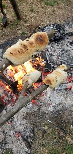 bread is being cooked over an open fire