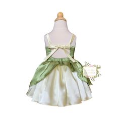 Not gonna lie, she’s my favorite! This dress is a statement. The soft buttery yellow and perfect green to match. The straps are adjustable for an easy fit. The skirt is double full and so fun to twirl in! No itchy tulle touching your little one. This one will stand out in the crowd. FREE custom sizing available. Matching bows and bloomers in the accessory collection of my shop. ***Please measure your child before selecting a size*** I will make the dress according to these measurements if person Green Princess Dress For Garden Party, Green Tutu Dress For Dress-up In Spring, Spring Green Tutu Dress For Dress-up, Summer Green Tutu Dress With Ruffles, Cute Dress With Adjustable Straps For Garden Party, Fitted Green Dress With Bow Tie Back, Green Fairy Dress For Spring Dress-up, Green Fairy Dress For Summer, Green Sleeveless Tutu Dress For Summer