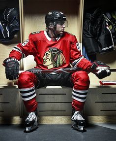 a hockey player sitting in the locker room