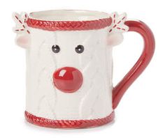 a red and white ceramic mug with a face on it