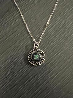 Looking for a unique and stylish necklace that will make a statement? Check out this beautiful petite round green flake antique finish necklace on Etsy! Handcrafted with care, this necklace features a stunning green flake design on a round pendant with an antique finish. The pendant is attached to an 18" stainless steel chain that is both durable and stylish. Perfect for dressing up any outfit, this necklace is a must-have for anyone who loves vintage or inspired jewelry. Green Oxidized Pendant Necklace, Vintage Green Necklace With Oxidized Finish, Green Round Nickel-free Necklace, Vintage May Birthstone Necklace, Green Round Pendant Metal Jewelry, Small Pendant Necklace, Stylish Necklace, Inspired Jewelry, Small Pendant