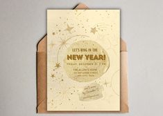 a new year's greeting card with gold foil stars and the words, let's ring in the new year