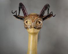 a wooden mask with horns on it's head