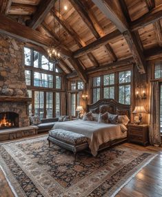 a large bed sitting inside of a bedroom on top of a wooden floor next to a fire place