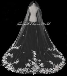 a black and white photo of a bride's wedding dress with flowers on it