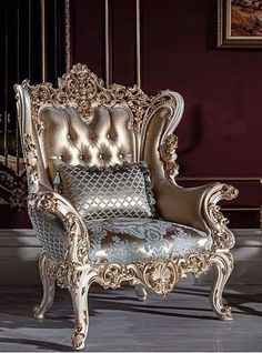 an ornate gold and silver chair in a room