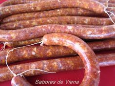 several sausages are laid out on a red surface