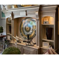 a large clock sitting on top of a wooden cabinet