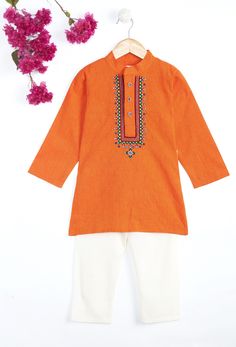 This Orange vibrant 100% cotton kurta pajama offers unique hand work Kutch embroidery at neck. It has stylish embroidery buttons and has Chinese collar kurta with comfortable white pajama's. It is an ideal choice for your little one's festive desires. SIZING TIP : * Please review the size chart for each outfit before making your size selection. more specifically look at the chest and length * If your child currently wears different sizes for top and bottom, please go with the smaller size of the two while picking the outfit FABRIC: Cotton (Kurta), Cotton (Pajama) WHATS INCLUDED: Kurta and Pajama CARE: Gentle Hand Wash or Dry clean for long lasting fabric shine. Garba Dress, Embroidery Kurta, Boys Kurta Design, Orange Embroidery, Boys Kurta, Diwali Sale, White Pajamas, Kurta Pyjama, Baby Boy Dress