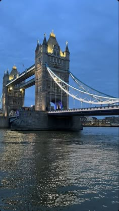 the tower bridge is lit up at night