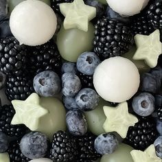 an assortment of fruits and candles are arranged in the shape of stars, snowflakes, and berries