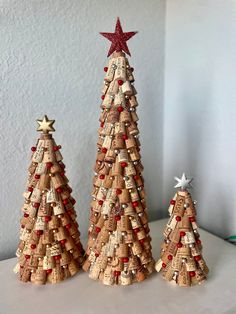 three cork christmas trees with red, white and gold decorations