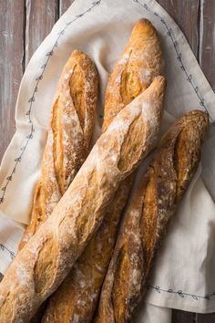 several loaves of bread sitting on top of a cloth