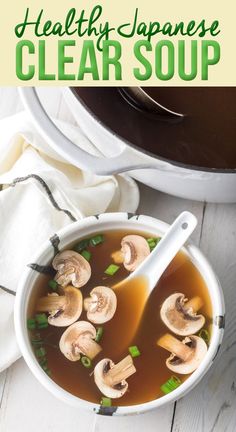 healthy japanese clear soup with mushrooms and green onions in a white bowl on a wooden table