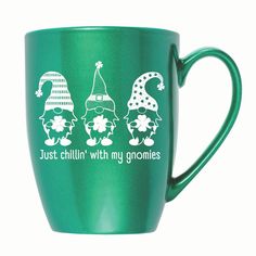 a green coffee mug with three gnomes on it's side and the words just chillin'with my gnomies