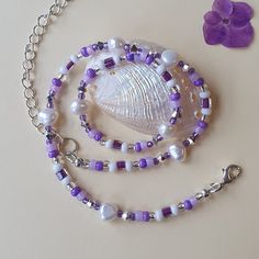 "A chic freshwater pearl and bead necklace handmade with natural freshwater pearls and seed beads in a cascade of pretty lilac, lavender, purple and white, with sparkling silver crystals.  THE BEADS: The seed beads are 4mm.  The freshwater pearls are 8mm.  THE CLASP AND EXTENSION CHAIN: The clasp and extension chain are silver-plated THE LENGTH: The necklace comes in 2 lengths and both are extendable by 5cm (2 inches) for individual fit: ◼️ 41cm (16 inch) collabone style necklace extends to 46 c Purple Bead Necklace, 16 Inch Necklace, Handmade Jewelry Necklace, Purple Necklace, Pretty Beads, Jewellery Uk, Seed Bead Necklace, Glass Bead Necklace, How To Make Beads