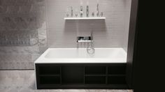 a white bath tub sitting next to a shelf filled with toothbrushes