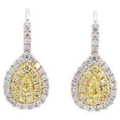 RareGemWorld's classic diamond earrings. Mounted in a beautiful 18K Yellow and White Gold setting with natural pear cut yellow diamonds. The yellow diamonds are surrounded by small round natural white diamond melee and small round natural yellow diamond melee. These earrings are guaranteed to impress and enhance your personal collection! Total Weight: 1.53cts   Length x Width: 23.8 x 10.8 mm Center Diamond Measurements: 5.0 x 3.0 mm Side Diamond Measurements: 1.5 - 1.7 mm  Natural Pear-Cut Yellow Diamonds  Natural Round White Diamonds Natural Round Yellow Diamonds 18K Yellow/White Gold All diamonds are guaranteed natural International Shipments: Please note that customers are responsible for all import duties and taxes applicable to the country of shipment Returns: Returns accepted in orig Classic Diamond Earrings, Earring Video, Yellow Gold Drop Earrings, Natural Cushions, White Gold Set, Cushion Diamond, Yellow Gold Setting, Pear Diamond, Gold Drop Earrings