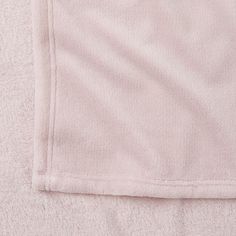 a pink blanket folded on top of each other