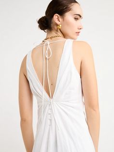 Adorn yourself with the elegance of the Sabrina Linen Maxi Dress in White. Crafted from Flax Linen fabrication for a relaxed easy fit, this maxi dress features a plunging neckline, a gathered twist front feature, functional linen-covered buttons, and a V-line open back with spaghetti tie fastening. With a graceful full skirt, this dress will be your go-to choice for summer getaways, birthday celebrations and refined holiday dressing. Holiday Dressing, Chic Evening Dress, V Line, Camilla And Marc, Linen Maxi Dress, Faithfull The Brand, Mini Dress Casual, Australian Fashion, Birthday Celebrations